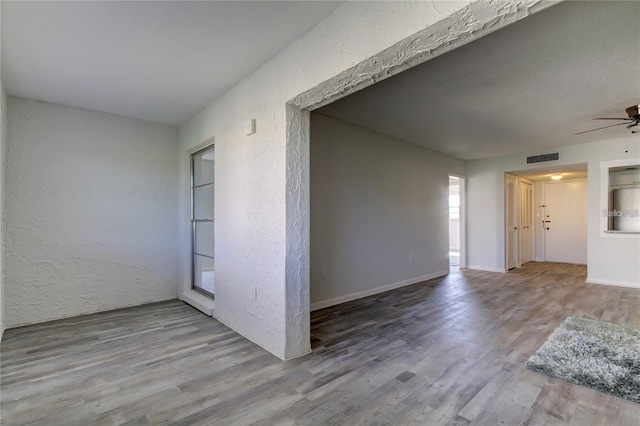 4901 Onyx Ln Unit 204, New Port Richey, FL 34652 - unfurnished room featuring ceiling fan, wood finished floors, and a textured wall