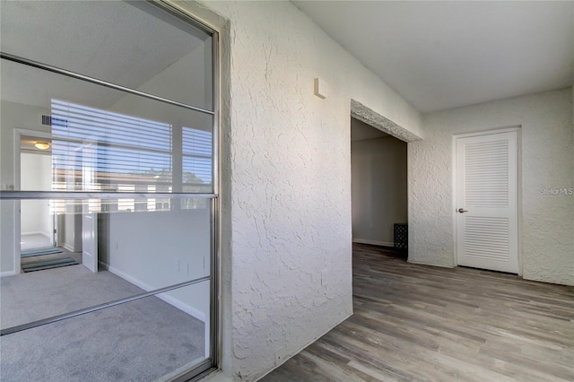 4901 Onyx Ln Unit 204, New Port Richey, FL 34652 - hall with a textured wall and wood finished floors