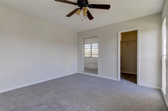 4901 Onyx Ln Unit 204, New Port Richey, FL 34652 - unfurnished bedroom with a walk in closet, carpet floors, ceiling fan, and a closet