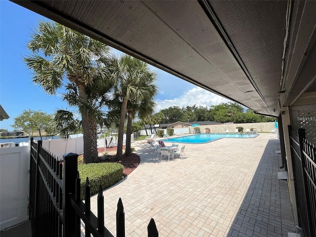 4901 Onyx Ln Unit 204, New Port Richey, FL 34652 - fenced backyard featuring a patio and a community pool