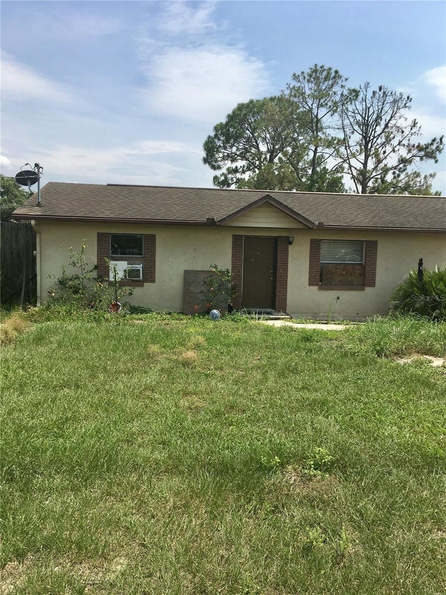 2532 Elm Ave, Lake Wales, FL 33898 - ranch-style home with a front yard and stucco siding