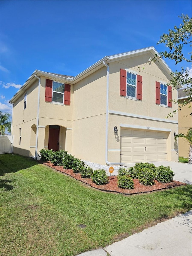 10124 Mangrove Well Rd, Ruskin, FL 33573 - traditional-style house with a garage, stucco siding, driveway, and a front yard