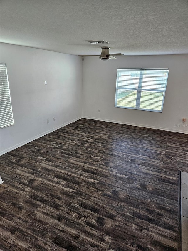 10124 Mangrove Well Rd, Ruskin, FL 33573 - empty room with dark wood-style floors, a textured ceiling, and ceiling fan