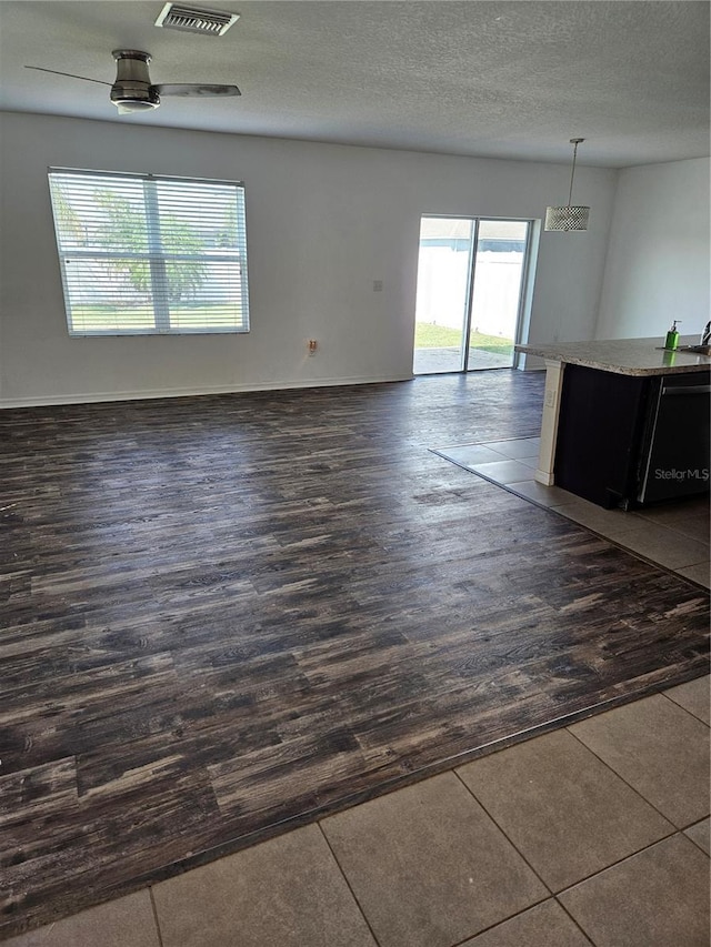10124 Mangrove Well Rd, Ruskin, FL 33573 - unfurnished room featuring dark wood-type flooring and a textured ceiling