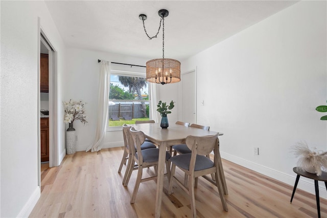 1720 Patlin Cir N, Largo, FL 33770 - dining space featuring a chandelier and light wood-type flooring