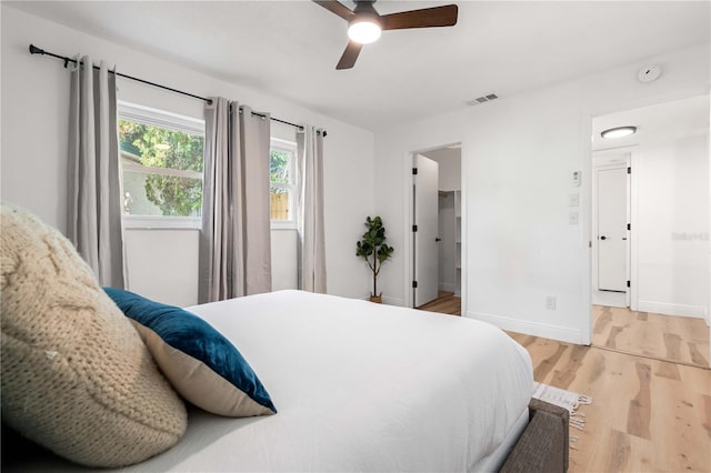 1720 Patlin Cir N, Largo, FL 33770 - bedroom featuring light wood-style floors, a ceiling fan, and a walk in closet