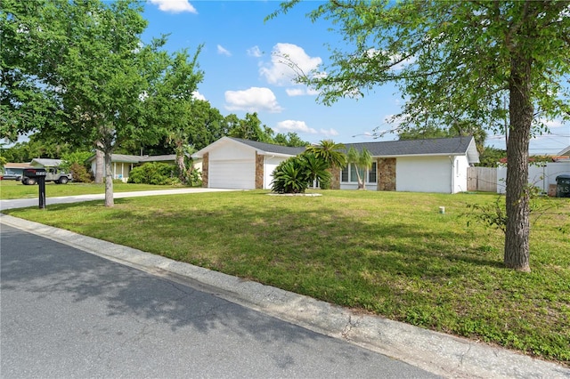 1720 Patlin Cir N, Largo, FL 33770 - ranch-style house with concrete driveway, an attached garage, and brick siding