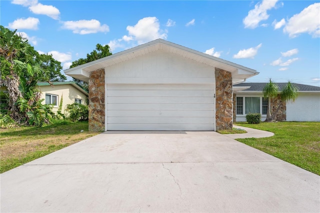 1720 Patlin Cir N, Largo, FL 33770 - ranch-style home featuring stone siding, an attached garage, a front yard, and concrete driveway