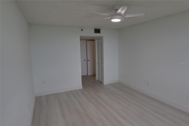 2333 Feather Sound Dr Unit A607, Clearwater, FL 33762 - spare room with light wood-style floors, a ceiling fan, and a textured ceiling
