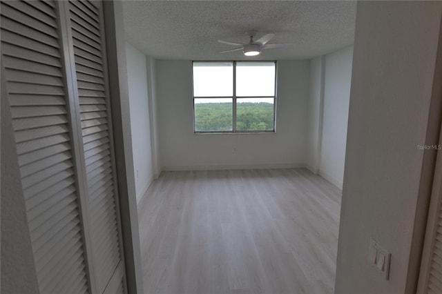 2333 Feather Sound Dr Unit A607, Clearwater, FL 33762 - unfurnished room with light wood-style flooring, a textured ceiling, and a ceiling fan