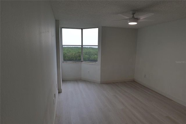 2333 Feather Sound Dr Unit A607, Clearwater, FL 33762 - empty room with a textured ceiling, light wood-style floors, and a ceiling fan