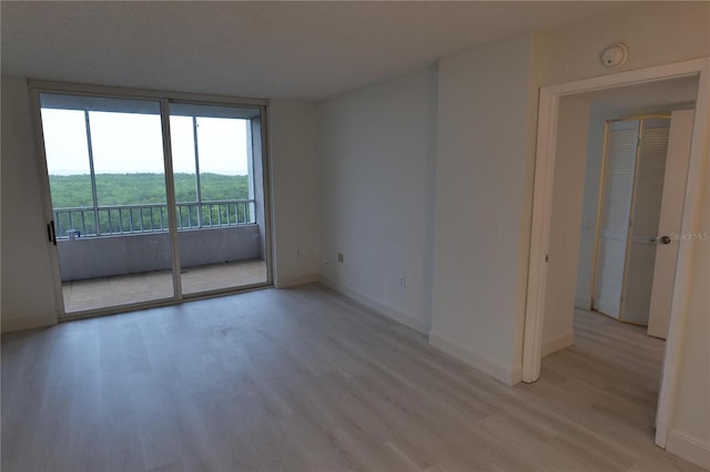 2333 Feather Sound Dr Unit A607, Clearwater, FL 33762 - unfurnished room featuring light wood-style floors and a smoke detector
