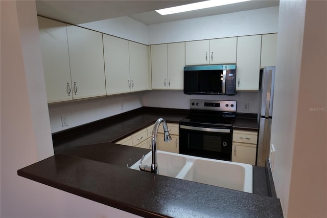 2333 Feather Sound Dr Unit A607, Clearwater, FL 33762 - kitchen with appliances with stainless steel finishes, dark countertops, and white cabinetry