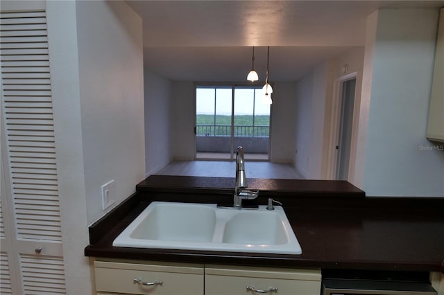 2333 Feather Sound Dr Unit A607, Clearwater, FL 33762 - kitchen with dark countertops, white cabinets, pendant lighting, and dishwashing machine