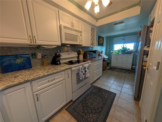 9510 Harbor Greens Way Unit 406, Seminole, FL 33776 - kitchen featuring white appliances, white cabinets, decorative backsplash, ceiling fan, and ornamental molding
