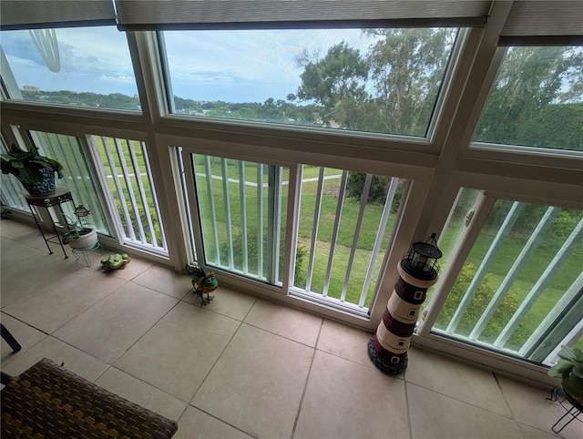 9510 Harbor Greens Way Unit 406, Seminole, FL 33776 - unfurnished sunroom featuring tile patterned floors and healthy amount of natural light