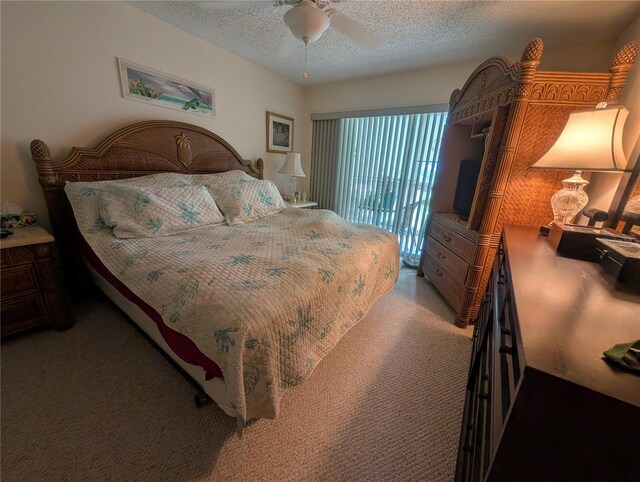 9510 Harbor Greens Way Unit 406, Seminole, FL 33776 - bedroom with carpet flooring, a textured ceiling, a ceiling fan, and access to outside