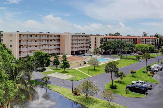 9510 Harbor Greens Way Unit 406, Seminole, FL 33776 - view of apartment building / complex featuring a water view