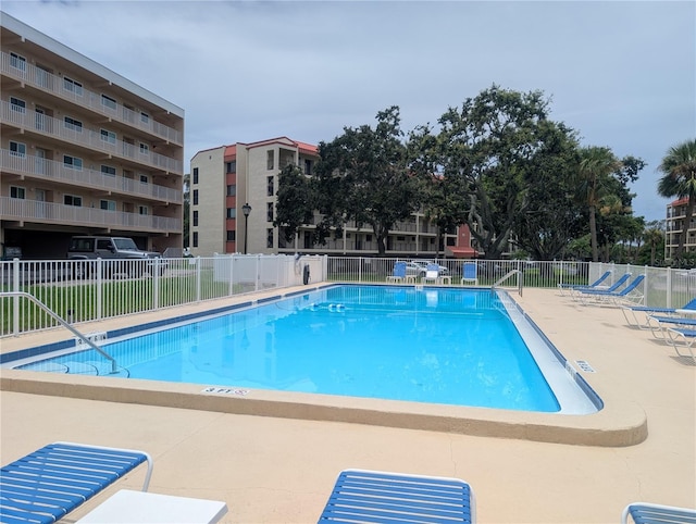 9510 Harbor Greens Way Unit 406, Seminole, FL 33776 - community pool featuring a patio