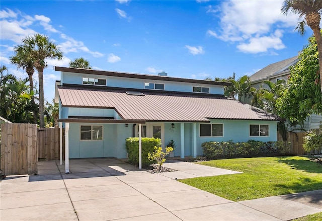 221 42nd Ave, St Pete Beach, FL 33706 - view of front of property featuring stucco siding, a metal roof, and a carport