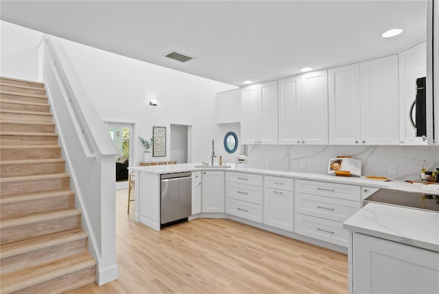 221 42nd Ave, St Pete Beach, FL 33706 - kitchen featuring dishwasher, white cabinets, a peninsula, light wood finished floors, and recessed lighting