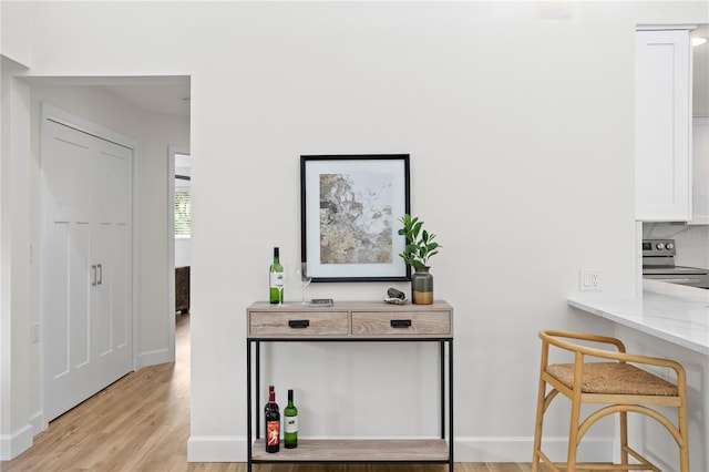 221 42nd Ave, St Pete Beach, FL 33706 - hall featuring light wood-style flooring and baseboards