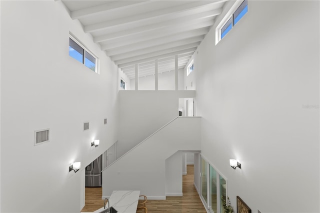 221 42nd Ave, St Pete Beach, FL 33706 - stairs with a high ceiling, wood finished floors, and beamed ceiling