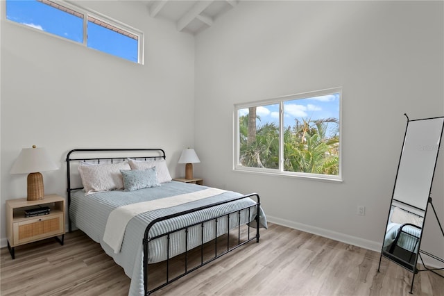 221 42nd Ave, St Pete Beach, FL 33706 - bedroom with a towering ceiling, light wood finished floors, and beam ceiling