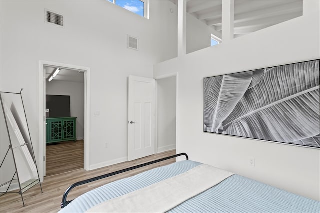 221 42nd Ave, St Pete Beach, FL 33706 - unfurnished bedroom with a high ceiling and wood finished floors
