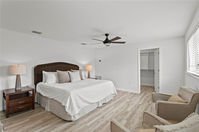 221 42nd Ave, St Pete Beach, FL 33706 - bedroom with light wood-style flooring, a walk in closet, ceiling fan, and a closet