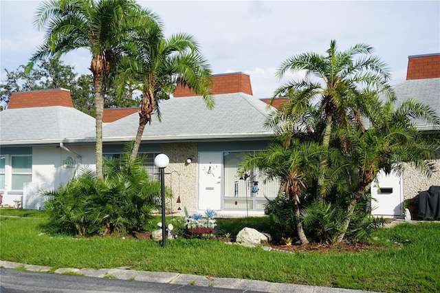 4329 Tahitian Gardens Cir Unit B, Holiday, FL 34691 - view of front facade with stucco siding and roof with shingles