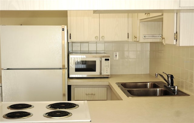 4329 Tahitian Gardens Cir Unit B, Holiday, FL 34691 - kitchen with white appliances, light countertops, and tasteful backsplash
