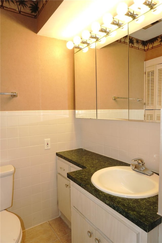 4329 Tahitian Gardens Cir Unit B, Holiday, FL 34691 - bathroom featuring vanity, tile walls, tile patterned floors, and a wainscoted wall