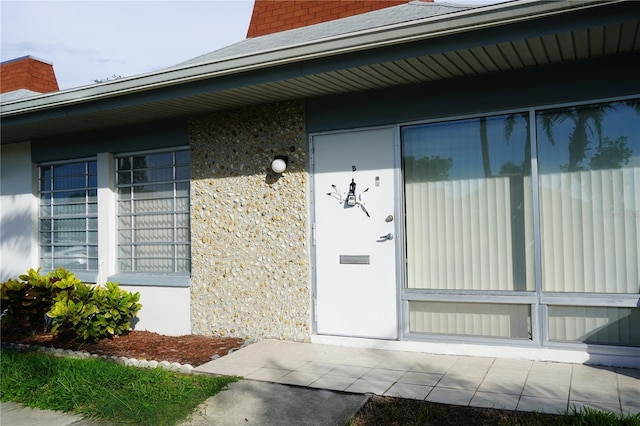 4329 Tahitian Gardens Cir Unit B, Holiday, FL 34691 - property entrance with a shingled roof and a chimney