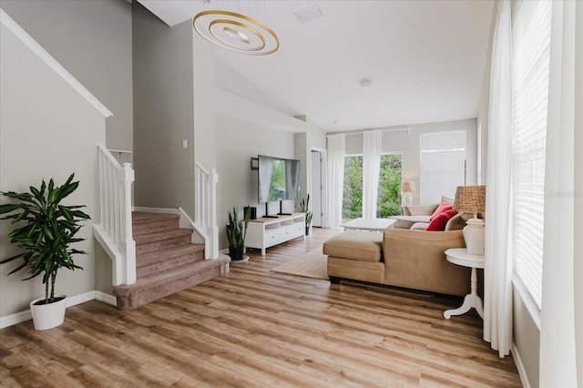 6260 Olivedale Dr, Riverview, FL 33578 - living room featuring high vaulted ceiling, stairs, and light wood-style flooring
