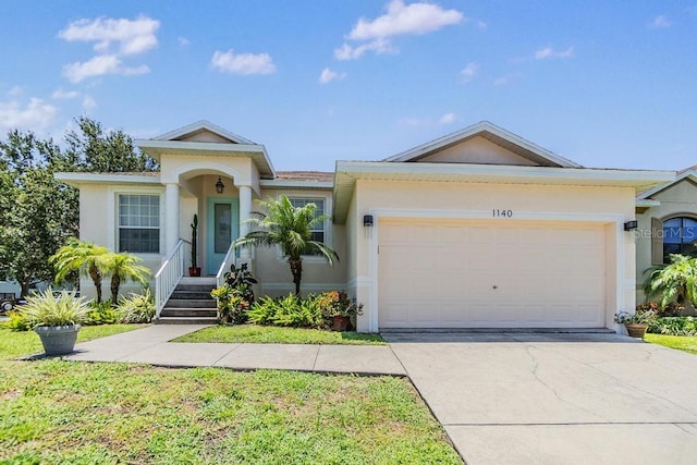 1140 S Pointe Alexis Dr, Tarpon Springs, FL 34689 - view of front of home with stucco siding, a garage, and concrete driveway
