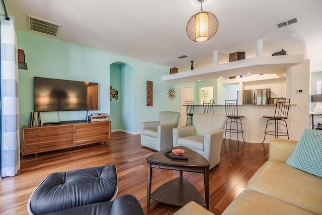1140 S Pointe Alexis Dr, Tarpon Springs, FL 34689 - living room with arched walkways and wood finished floors