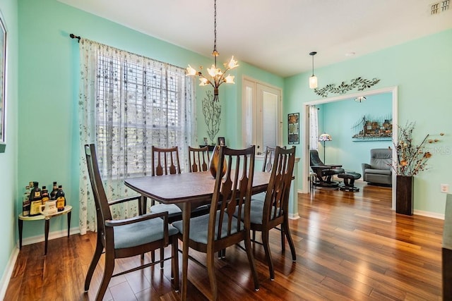 1140 S Pointe Alexis Dr, Tarpon Springs, FL 34689 - dining room with a chandelier and wood finished floors