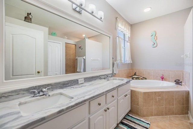 1140 S Pointe Alexis Dr, Tarpon Springs, FL 34689 - full bath featuring a garden tub, tile patterned floors, and double vanity