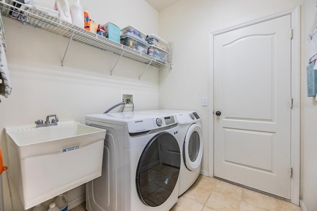 1140 S Pointe Alexis Dr, Tarpon Springs, FL 34689 - washroom featuring washing machine and dryer and light tile patterned floors