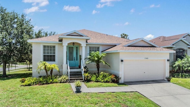 1140 S Pointe Alexis Dr, Tarpon Springs, FL 34689 - view of front facade featuring a garage, a front yard, stucco siding, and roof with shingles