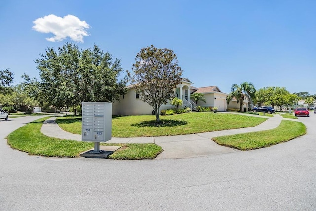 1140 S Pointe Alexis Dr, Tarpon Springs, FL 34689 - view of front facade featuring a front lawn and stucco siding