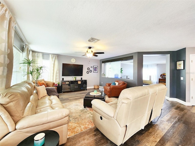 3112 Kearns Rd, Mulberry, FL 33860 - living room with dark wood-style floors, a textured ceiling, and a ceiling fan