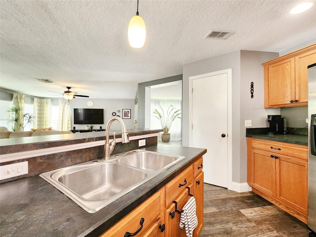 3112 Kearns Rd, Mulberry, FL 33860 - kitchen with dark countertops, open floor plan, a ceiling fan, a textured ceiling, and dark wood-style flooring