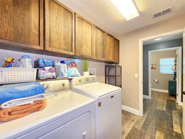 3112 Kearns Rd, Mulberry, FL 33860 - washroom featuring cabinet space, washing machine and dryer, and wood finished floors