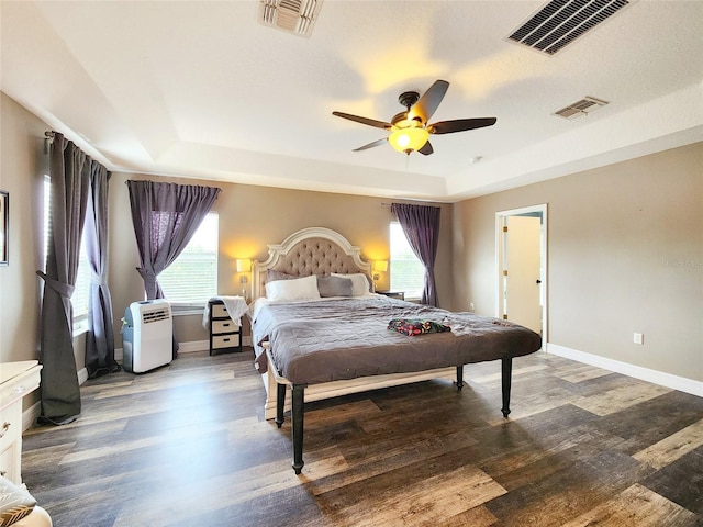 3112 Kearns Rd, Mulberry, FL 33860 - bedroom with a raised ceiling, wood finished floors, multiple windows, and a ceiling fan