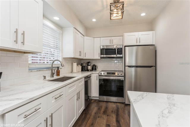 2207 S Carolina Ave Unit 10, Tampa, FL 33629 - kitchen featuring appliances with stainless steel finishes, white cabinets, light stone counters, and recessed lighting