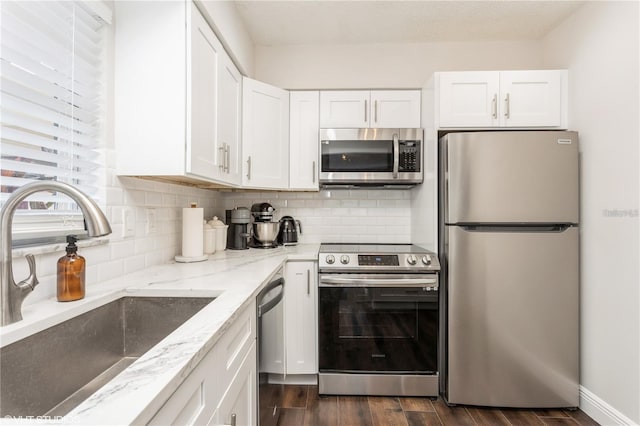 2207 S Carolina Ave Unit 10, Tampa, FL 33629 - kitchen featuring appliances with stainless steel finishes, white cabinetry, and dark wood-style floors