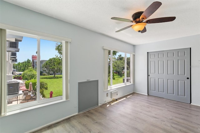 2370 Jamaican St Unit 44, Clearwater, FL 33763 - unfurnished bedroom with wood finished floors, a closet, ceiling fan, and a textured ceiling