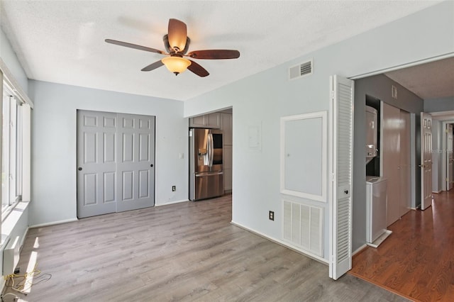 2370 Jamaican St Unit 44, Clearwater, FL 33763 - unfurnished bedroom with stainless steel refrigerator with ice dispenser, wood finished floors, and a ceiling fan